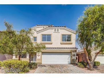 Charming two-story home with a brick driveway, manicured landscaping, and attached two car garage at , North Las Vegas, NV 89031