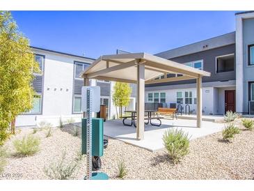 A community picnic area offers residents a shady place to sit and relax outdoors at 139 Aqua Commons Ln, Henderson, NV 89015