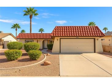 Charming single-story home featuring a red tile roof, desert landscaping, and a spacious two-car garage at 1619 Abby Ave, Henderson, NV 89014