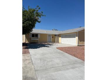 Cozy single-story home featuring an attached two-car garage, neutral paint and low maintenance landscaping at 1809 Lamplighter Ln, Las Vegas, NV 89104
