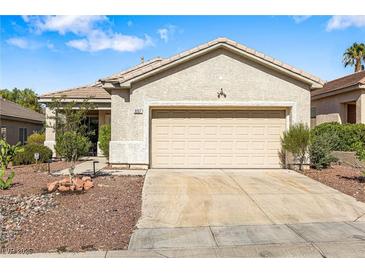 Charming single-story home featuring a two-car garage and low maintenance desert landscaping at 3257 Rushing Waters Pl, Las Vegas, NV 89135