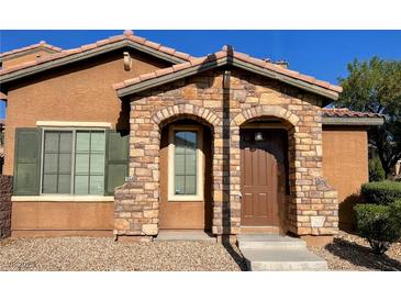Charming home entrance featuring a stone archway and warm, inviting tones at , Las Vegas, NV 89178