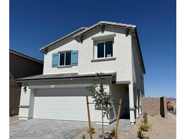 Charming two-story home featuring a two car garage and a well-maintained yard with blue shutters at 10442 Luna Mezza Ave # Lot 187, Las Vegas, NV 89141