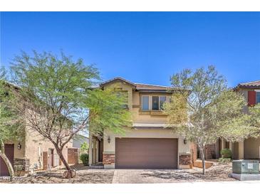 Charming two-story home featuring a two-car garage and desert landscaping in front at 2300 Sky Island Dr, Henderson, NV 89002