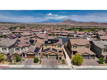 Beautiful neighborhood with mountain views, complemented by lush landscaping and solar panels on the roofs at 242 Polaris Ridge Ave, Henderson, NV 89011