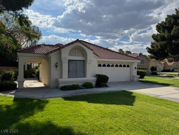 Charming single-story home with a well-maintained lawn and attached two-car garage at 5401 Painted Sunrise Dr, Las Vegas, NV 89149