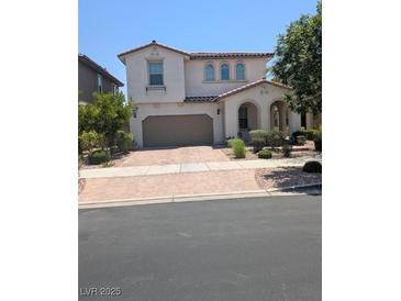 Charming two-story home with a tile roof, arched entry, and a two-car garage at 600 Our Heritage St, Henderson, NV 89011
