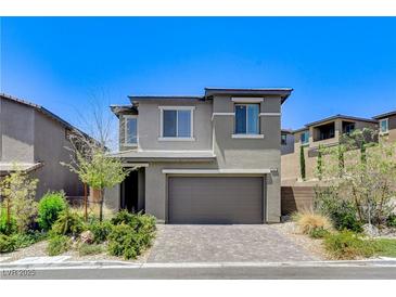 Charming two-story home with a well-manicured lawn and a two-car garage at 689 Rogue Wave St, Las Vegas, NV 89138