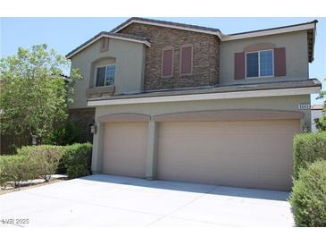 Charming two-story home featuring a two-car garage and stone accents on the upper level at 9065 Mastodon Ave, Las Vegas, NV 89149
