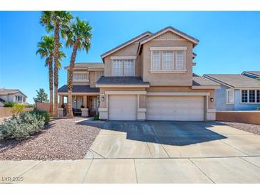 Inviting two-story home with three-car garage, manicured landscaping, and desert-friendly rock groundcover at 98 Milicity Rd, Henderson, NV 89012