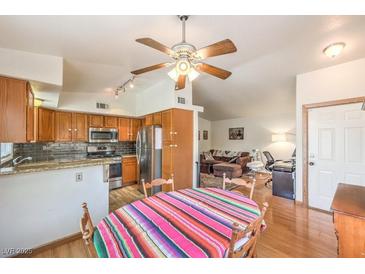 Open kitchen area with stainless steel appliances and adjacent living area at 520 Arrowhead Trl # 522, Henderson, NV 89015