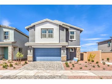 Charming two-story home featuring a blue garage door, neutral gray paint, and low-maintenance landscaping at 549 Ruby Robin Ave # 751, Henderson, NV 89011