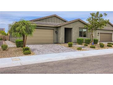 Charming single-story home featuring desert landscaping, a two-car garage and brick paved driveway at 6519 Summershade St, North Las Vegas, NV 89086