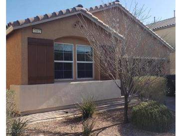 Charming single-story home featuring a neutral stucco exterior, complemented by a tile roof and a well-maintained front yard at 7112 Whitford St, Las Vegas, NV 89166