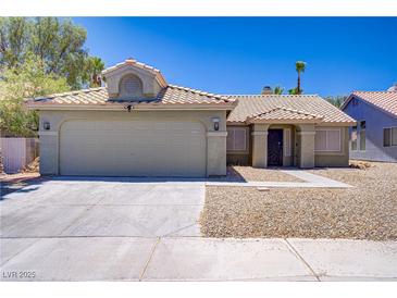 Charming single-story home featuring a two-car garage and desert landscaping for easy maintenance at 7713 White Grass Ave, Las Vegas, NV 89131