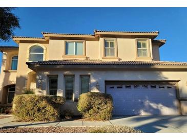 Charming two-story home featuring an attached garage and well-maintained landscaping at 7728 Villa De La Paz Ave, Las Vegas, NV 89131