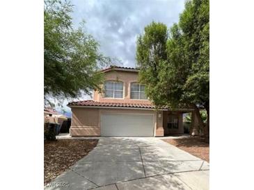 Charming home with a two-car garage, desert landscaping, and a red tile roof at 994 River Walk Ct, Henderson, NV 89015