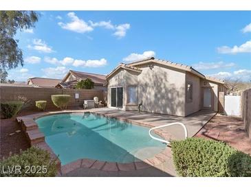 Backyard pool offers a private outdoor oasis, perfect for relaxation and entertaining in a desirable neighborhood at 11076 Zampino St, Las Vegas, NV 89141