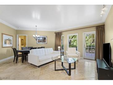 Bright living room with a white sofa set, glass table, tile flooring, and natural light from the windows at 30 Strada Di Villaggio # 118, Henderson, NV 89011
