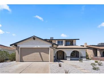 Inviting two-story home showcasing desert landscaping and a convenient two-car garage at 307 Balsa St, Henderson, NV 89002