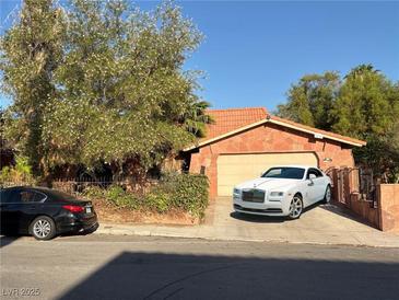 Charming single-story home with stone accents, a tile roof, and a well-manicured front yard at 3167 El Cedro Cir, Las Vegas, NV 89121