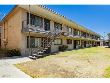 Charming two-story apartment complex featuring a well-maintained lawn and exterior stairs at 3718 Hazelwood St # 7, Las Vegas, NV 89119