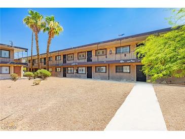 Apartment building featuring a central courtyard with mature palm trees and walkways at 3720 Royal Crest St # 6, Las Vegas, NV 89119