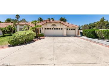 Charming single-story home showcasing a well-manicured front yard and a spacious three-car garage at 399 Discovery Ct, Henderson, NV 89014