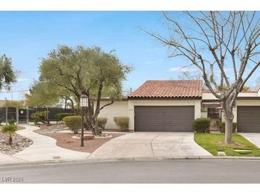 Single story home featuring desert landscaping, and a red tile roof, and two-car garage at 4687 Madreperla St, Las Vegas, NV 89121