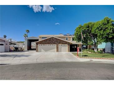 Charming two-story home featuring a three-car garage and mature landscaping at 902 Dianne Dr, Boulder City, NV 89005
