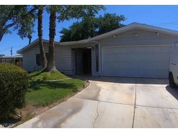 Charming single-story home featuring a two-car garage and a well-maintained, partially shaded front yard at 912 Saylor Way, Las Vegas, NV 89108
