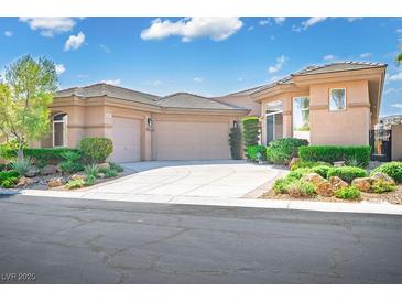 Charming single story home with a desert rock garden and a three car garage and well-maintained landscaping at 9233 Canyon Mesa Dr, Las Vegas, NV 89144