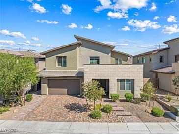 Two-story home featuring desert landscaping, a two-car garage, and a stylish exterior at 12415 Notch Trail Ave, Las Vegas, NV 89138