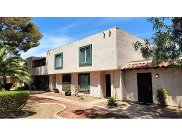 A view of the home's exterior showing desert landscaping and unique architectural design at 3453 Del Marino Dr, Las Vegas, NV 89121