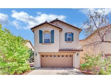 Charming two-story home featuring a well-manicured lawn, a two-car garage, and decorative shutters at 3741 Via Gaetano, Henderson, NV 89052