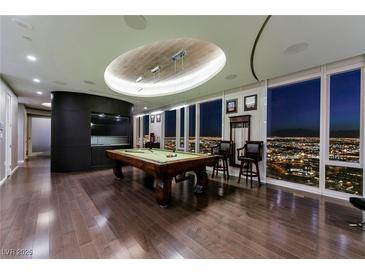 Elegant game room featuring a billiard table, hardwood floors, and expansive windows showcasing city views at 3750 S Las Vegas Blvd # 4507, Las Vegas, NV 89158