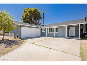 Charming single-story home with a well-maintained front yard and a two-car garage at 4492 Rita Dr, Las Vegas, NV 89121