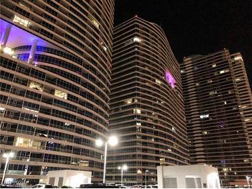 Exterior night view of modern high rise buildings with illuminated windows and balconies at 4575 Dean Martin Dr # 303, Las Vegas, NV 89103