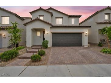 Two-story home features a tile roof, desert landscaping, and a two-car garage at 9947 Fletcher Peak Ave, Las Vegas, NV 89178