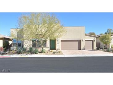 Contemporary single-story home with desert landscaping and a three-car garage at 2170 Monte Bianco Pl, Henderson, NV 89044