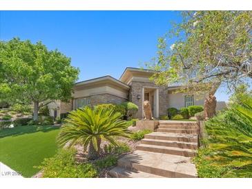 Stunning single-story home with stone accents, manicured lawn, and inviting landscaped entrance at 3048 Red Arrow Dr, Las Vegas, NV 89135
