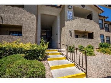 Inviting exterior view of condo building with well-maintained landscaping and stairs to the units at 2451 N Rainbow Blvd # 1116, Las Vegas, NV 89108