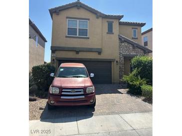 Two-story home showcasing a well-maintained yard and charming architectural details at 7064 Coventry Glenn Rd, Las Vegas, NV 89148