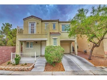 Two-story home featuring a balcony, attached garage, and a well-maintained front yard at 6621 Churnet Valley Ave, Las Vegas, NV 89139