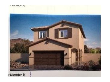 Inviting two-story home with a two-car garage and desert landscaping at 7430 Bo Gable Falls Pl # 54, North Las Vegas, NV 89084