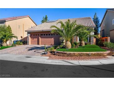 Charming single-story home featuring a well-manicured yard, desert landscaping, and a spacious three-car garage at 10042 Pipestone St, Las Vegas, NV 89141