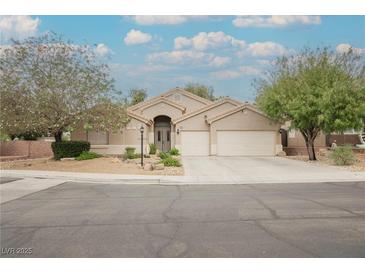 Charming single-story home features a well-manicured yard and a three-car garage at 1598 Cowboy Chaps Pl, Henderson, NV 89002