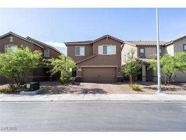Two story home featuring a two car garage, brick paved driveway and low maintenance landscaping at 3553 Judson Ave, Las Vegas, NV 89115