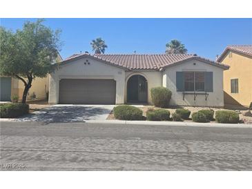 Charming single-story home with a well-maintained front yard and a two-car garage at 7572 Coyote Cave Ave, Las Vegas, NV 89113