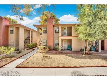Attractive two-story exterior with private balconies and well-maintained landscaping at 5576 W Rochelle Ave # 9C, Las Vegas, NV 89103